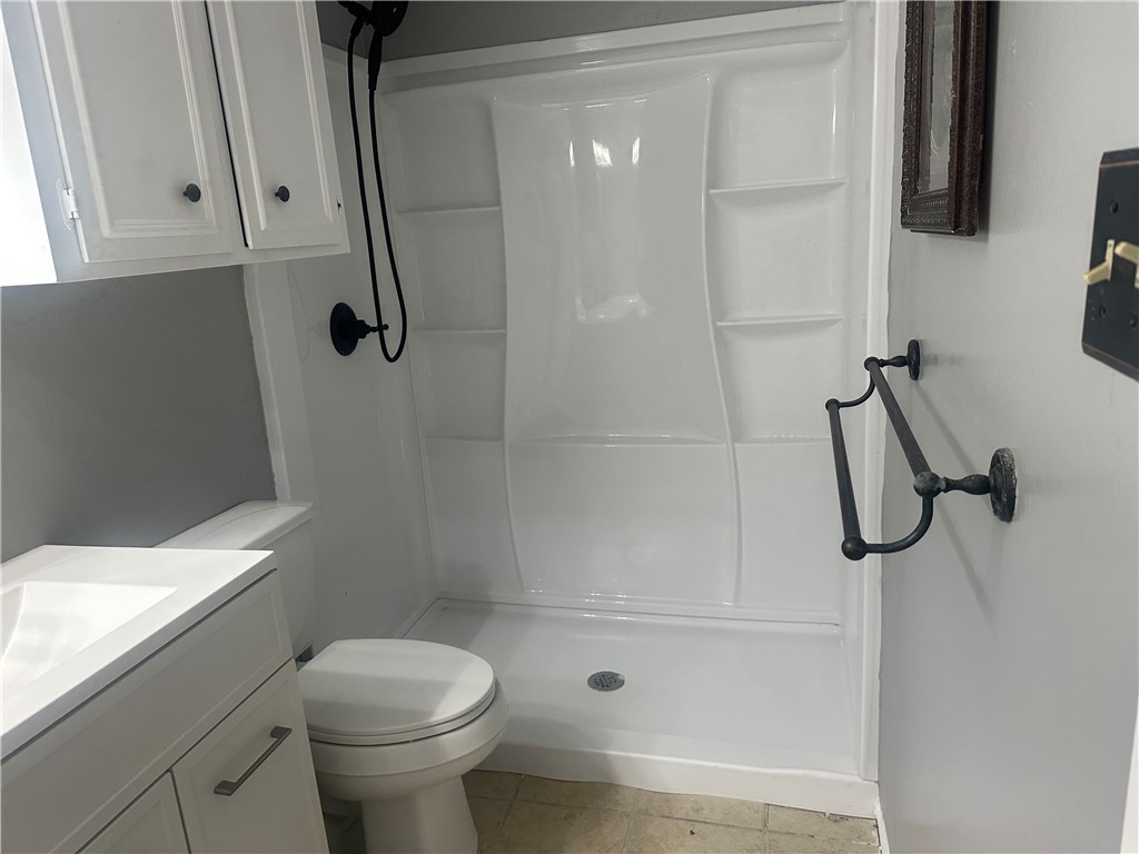 4032 Ogrady Drive Corpus Christi, TX 78413 - Photo 14 of 18 a bathroom with a shower toilet and sink