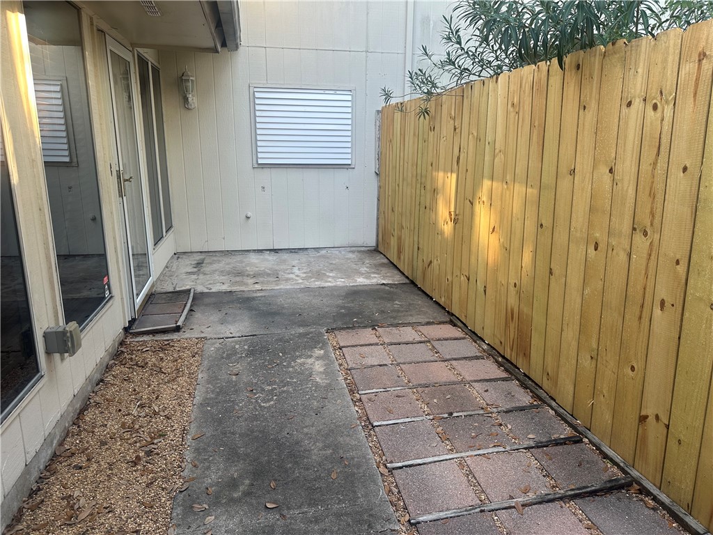 4032 Ogrady Drive Corpus Christi, TX 78413 - Photo 18 of 18 a view of a back yard with wooden fence and a window