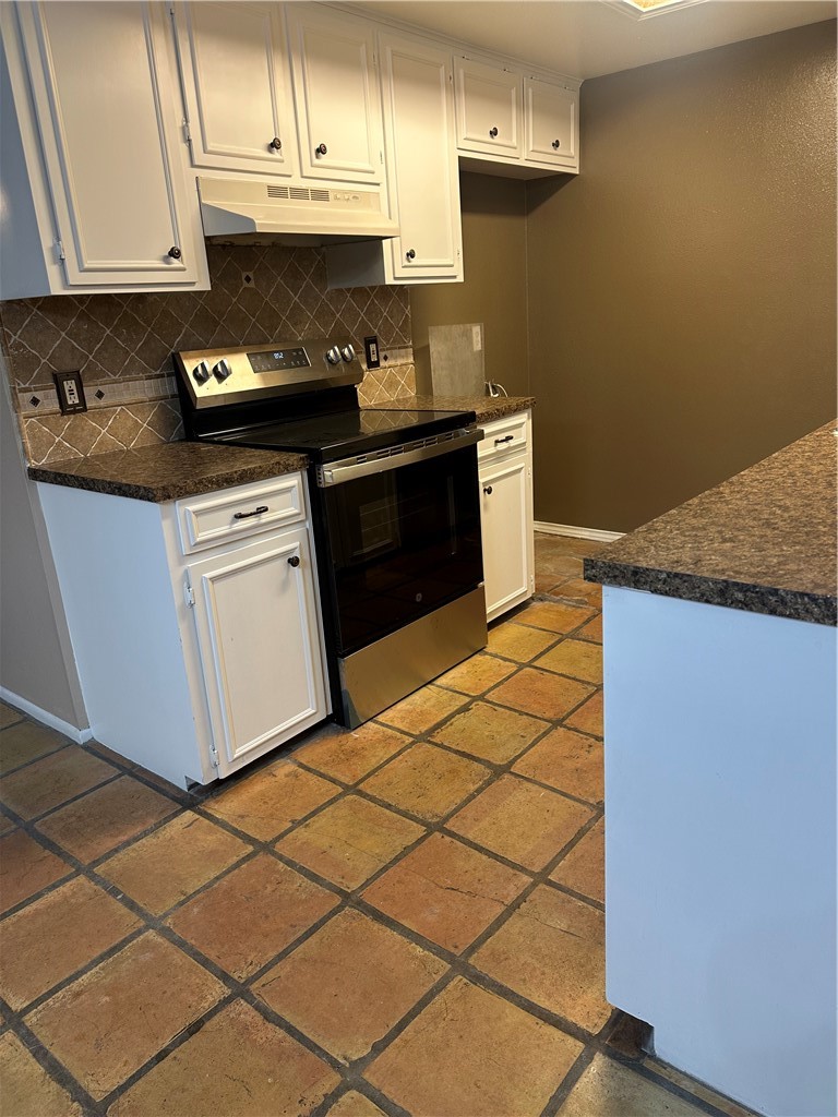 4032 Ogrady Drive Corpus Christi, TX 78413 - Photo 7 of 18 a kitchen with stainless steel appliances granite countertop a stove a sink and a microwave