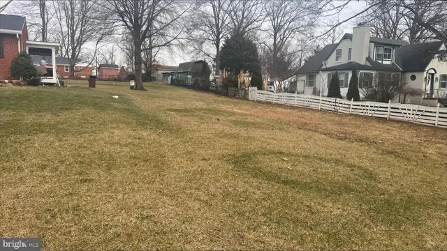 a tall house with trees in front of it