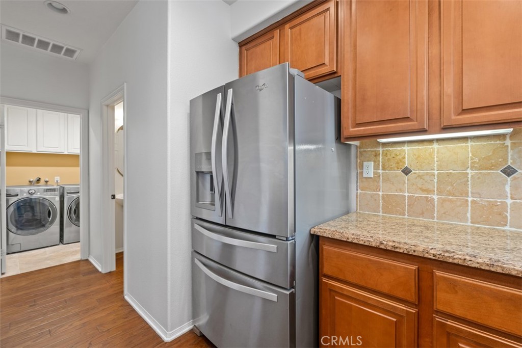 40 League Irvine, CA 92602 - Photo 11 of 38 a kitchen with stainless steel appliances granite countertop a refrigerator and a sink