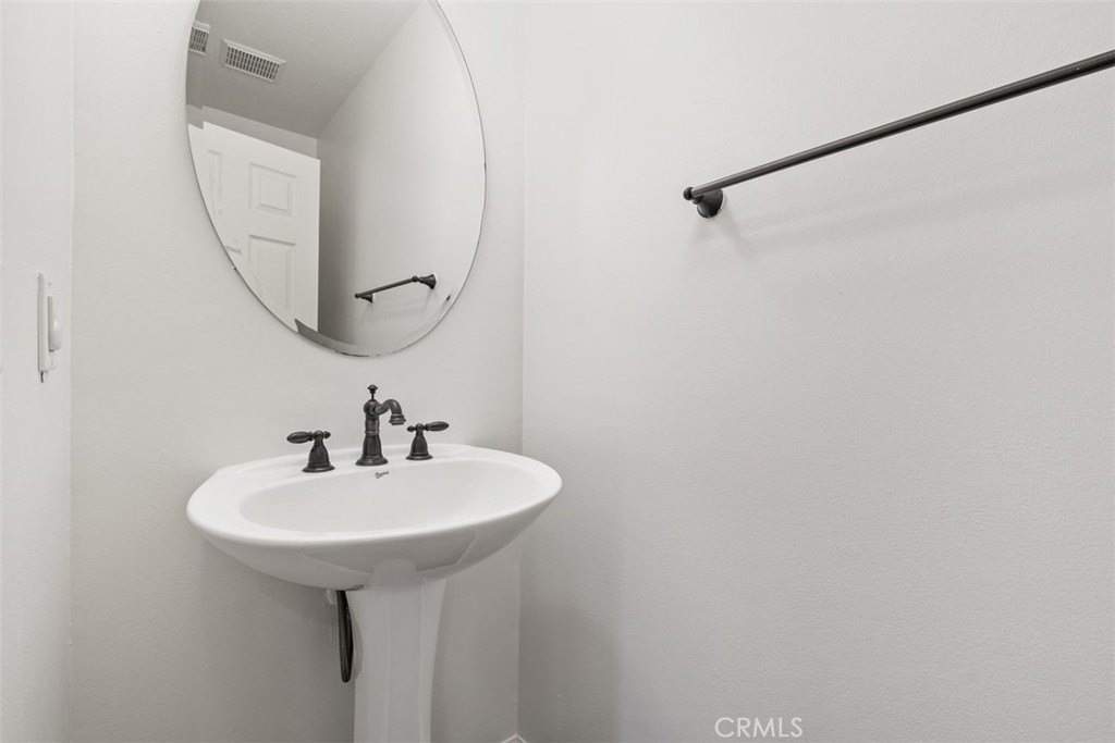 40 League Irvine, CA 92602 - Photo 12 of 38 a bathroom with a sink and a mirror