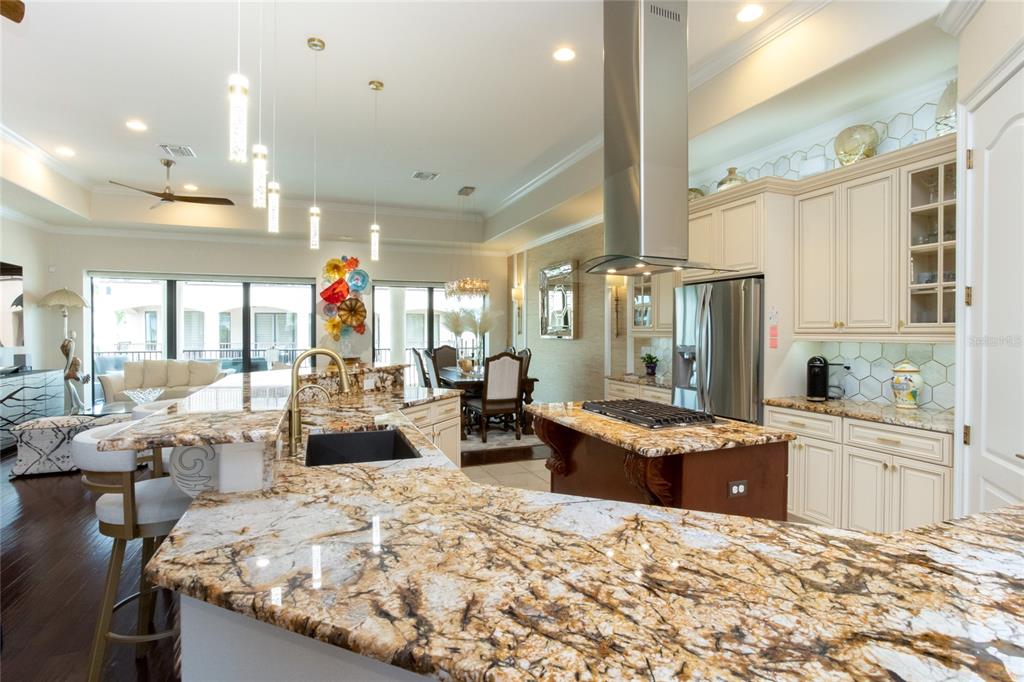 105 Wimbledon Court Redington Shores, FL 33708 - Photo 22 of 64 a large white kitchen with granite countertop a stove and white cabinets