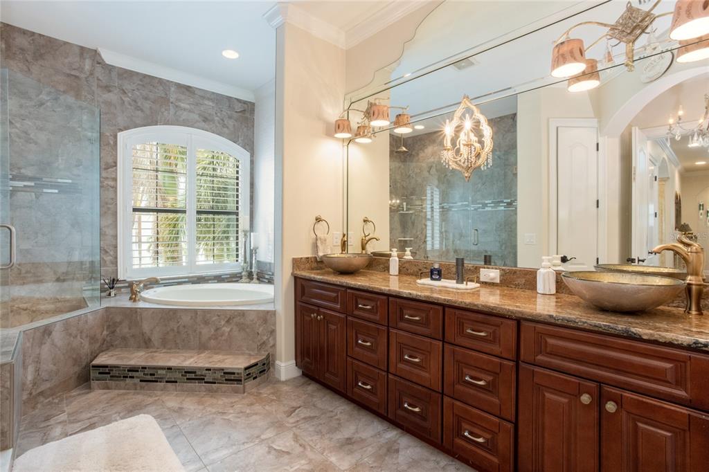 105 Wimbledon Court Redington Shores, FL 33708 - Photo 25 of 64 a bathroom with a granite countertop tub sink and double vanity