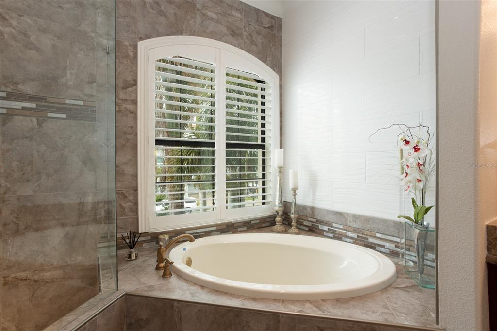 105 Wimbledon Court Redington Shores, FL 33708 - Photo 29 of 64 a bathroom with a tub and shower