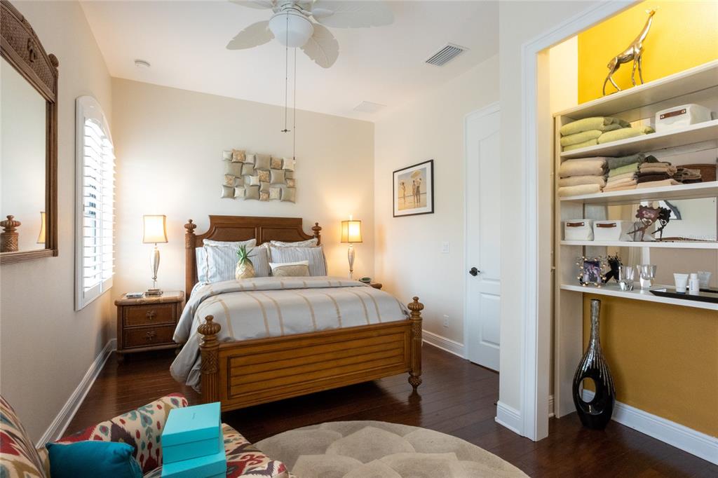 105 Wimbledon Court Redington Shores, FL 33708 - Photo 35 of 64 a bedroom with a bed and a chandelier