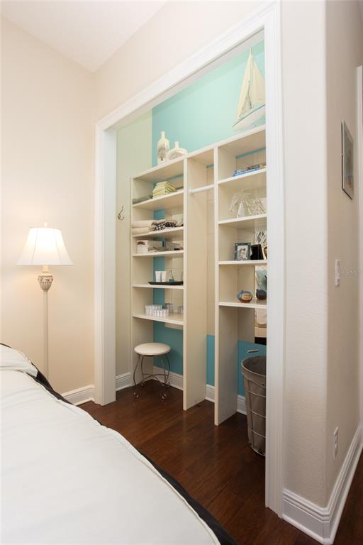 105 Wimbledon Court Redington Shores, FL 33708 - Photo 42 of 64 a bedroom with a bed and a lamp on the dresser