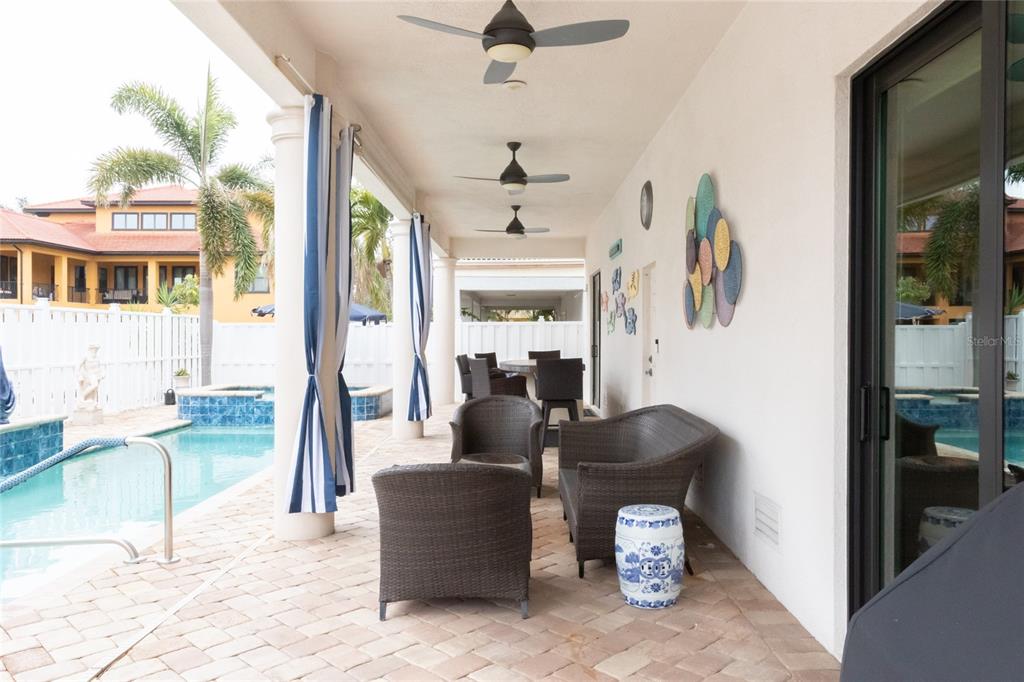 105 Wimbledon Court Redington Shores, FL 33708 - Photo 58 of 64 a living room with furniture and a chandelier