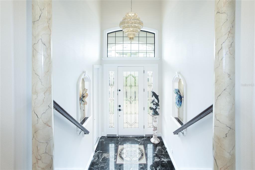 105 Wimbledon Court Redington Shores, FL 33708 - Photo 6 of 64 a view of entryway with wooden floor and stairs