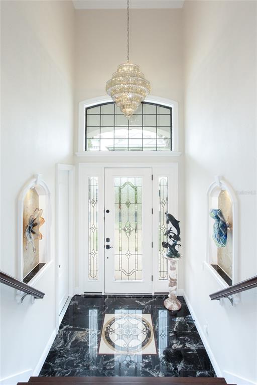 105 Wimbledon Court Redington Shores, FL 33708 - Photo 7 of 64 a living room with furniture and a chandelier