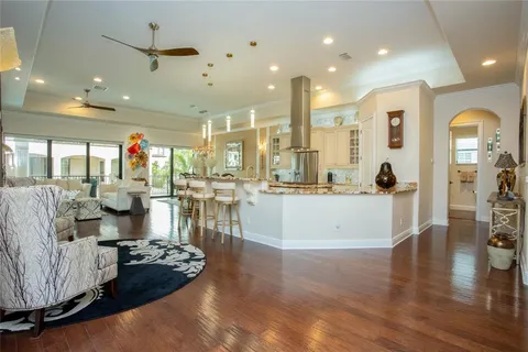a living room with furniture a flat screen tv and a floor to ceiling window
