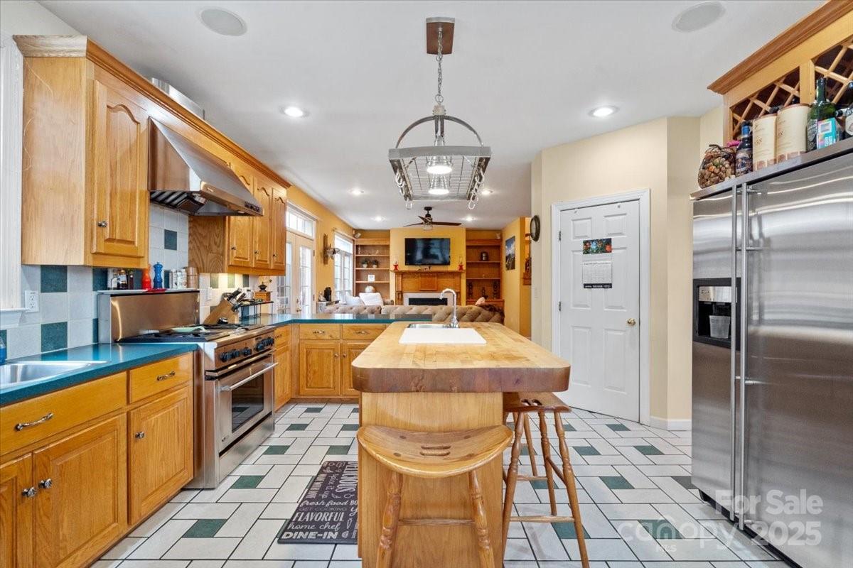 4594 Grandin Road Lenoir, NC 28645 - Photo 14 of 44 a kitchen with stainless steel appliances kitchen island granite countertop a refrigerator a stove and a sink with cabinets
