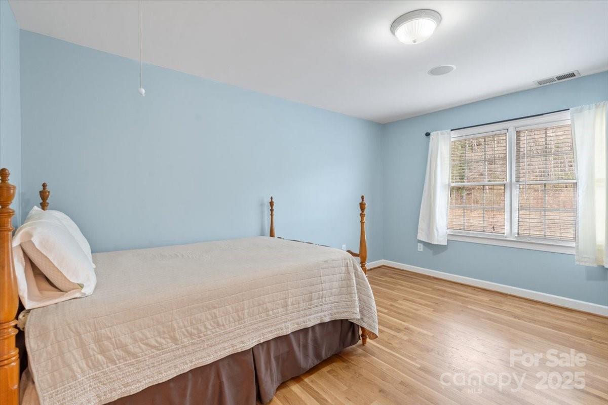 4594 Grandin Road Lenoir, NC 28645 - Photo 18 of 44 a bedroom with a bed and wooden floor