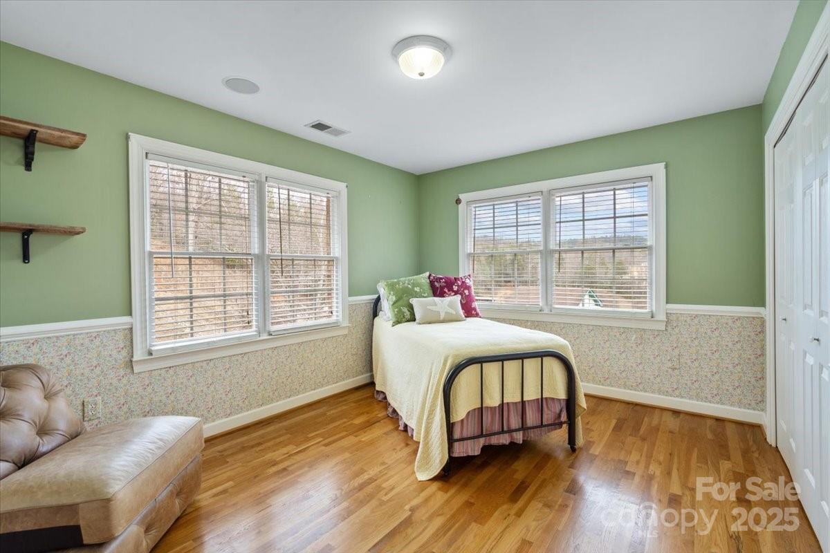 4594 Grandin Road Lenoir, NC 28645 - Photo 20 of 44 a bedroom with a bed and wooden floor
