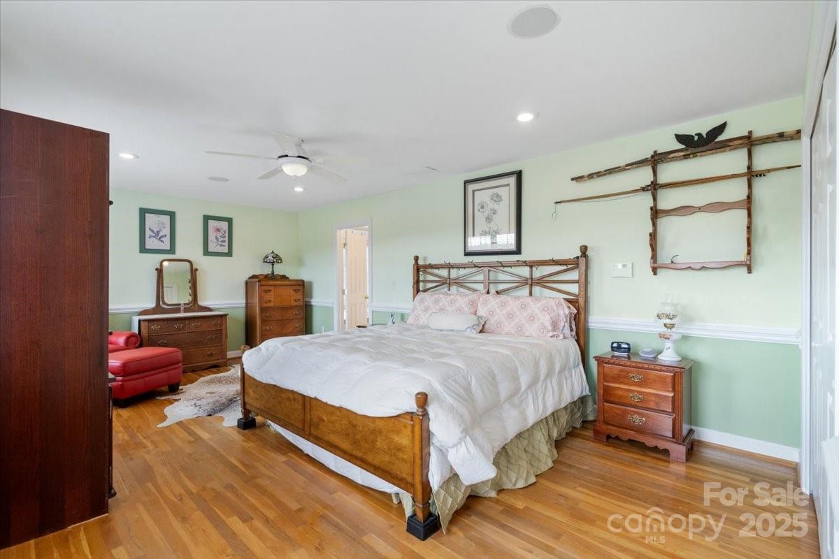 4594 Grandin Road Lenoir, NC 28645 - Photo 22 of 44 a bedroom with a bed and a chandelier