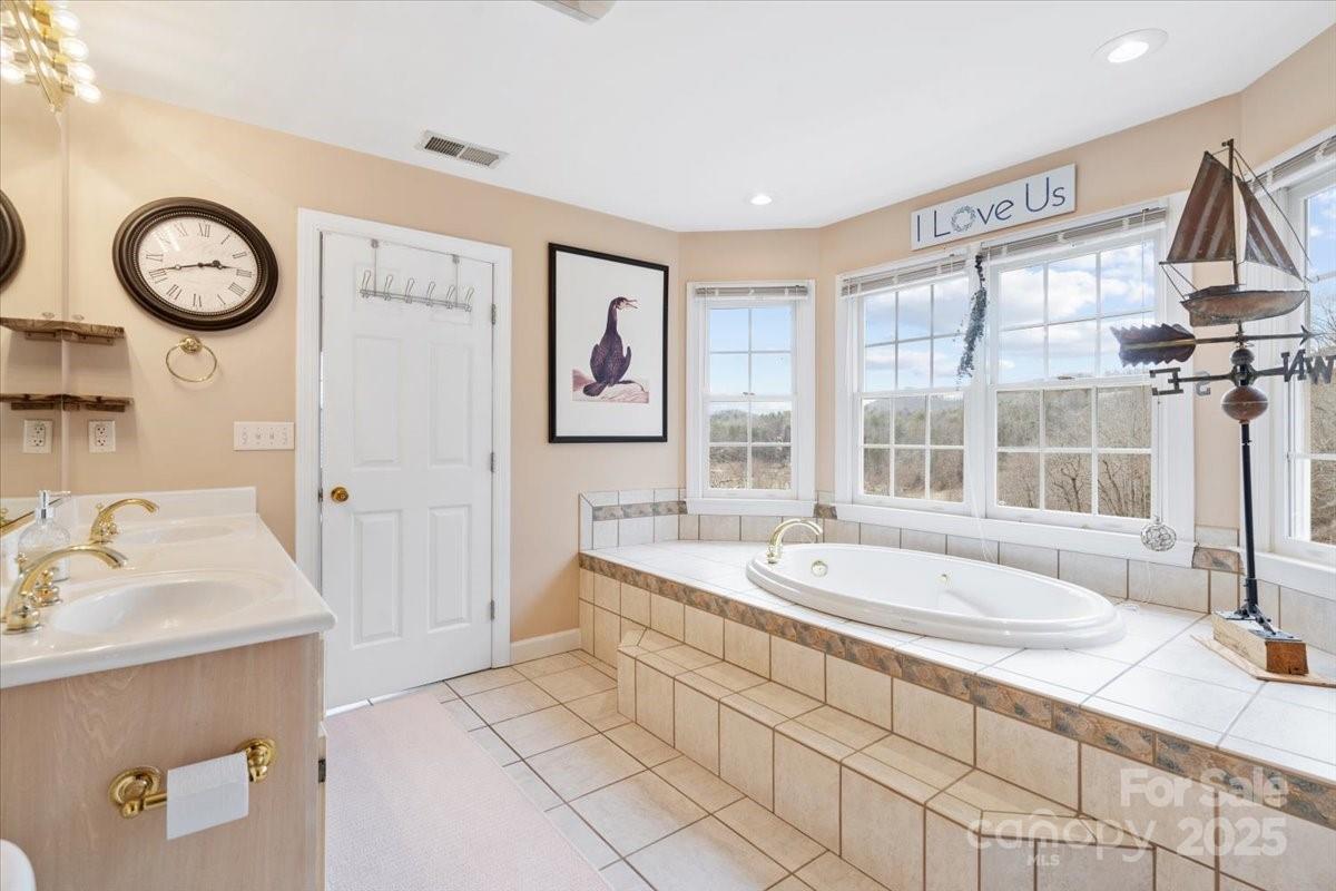 4594 Grandin Road Lenoir, NC 28645 - Photo 26 of 44 a spacious bathroom with a tub sink and mirror