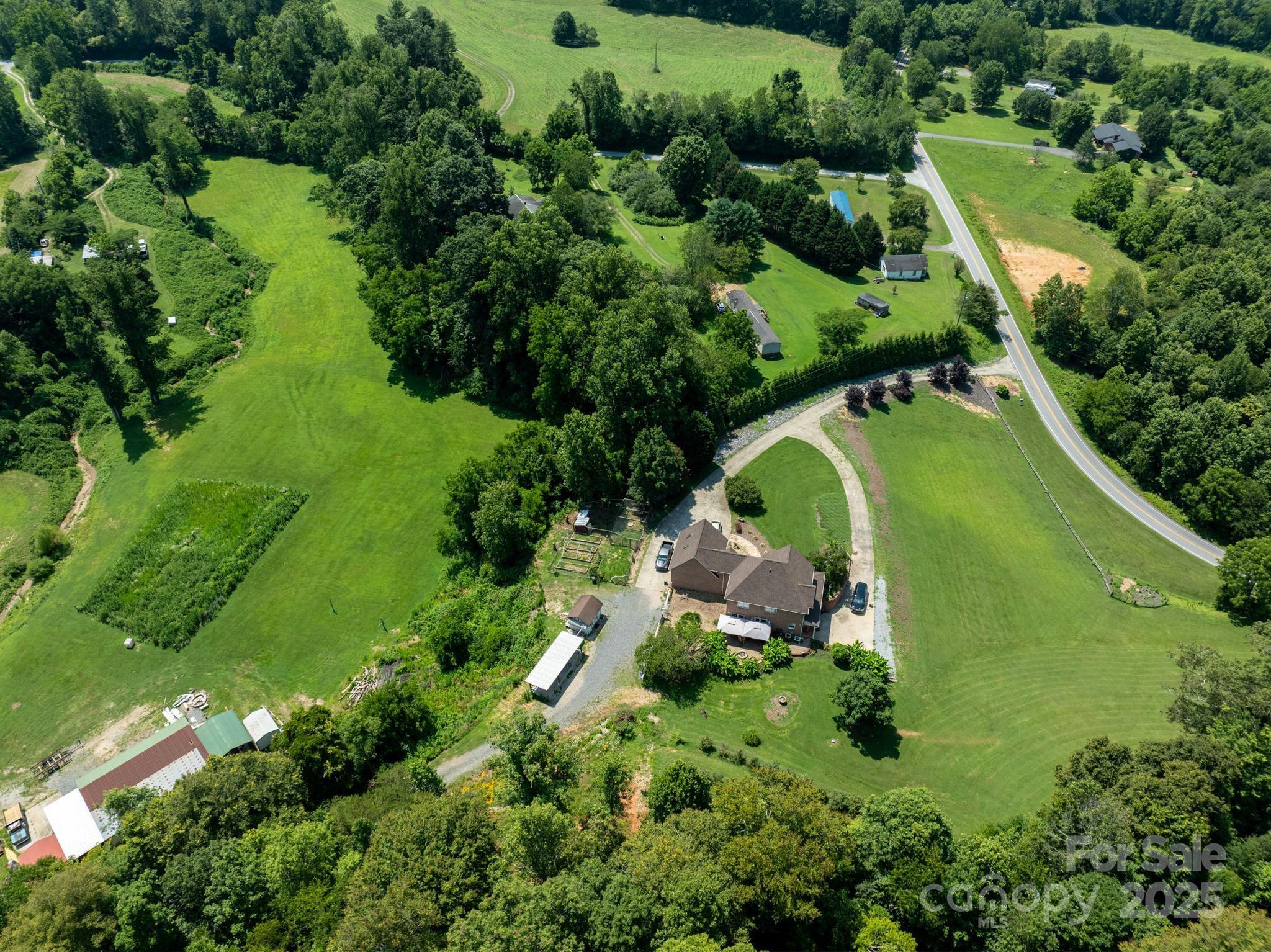 4594 Grandin Road Lenoir, NC 28645 - Photo 39 of 44 an aerial view of a garden with swimming pool