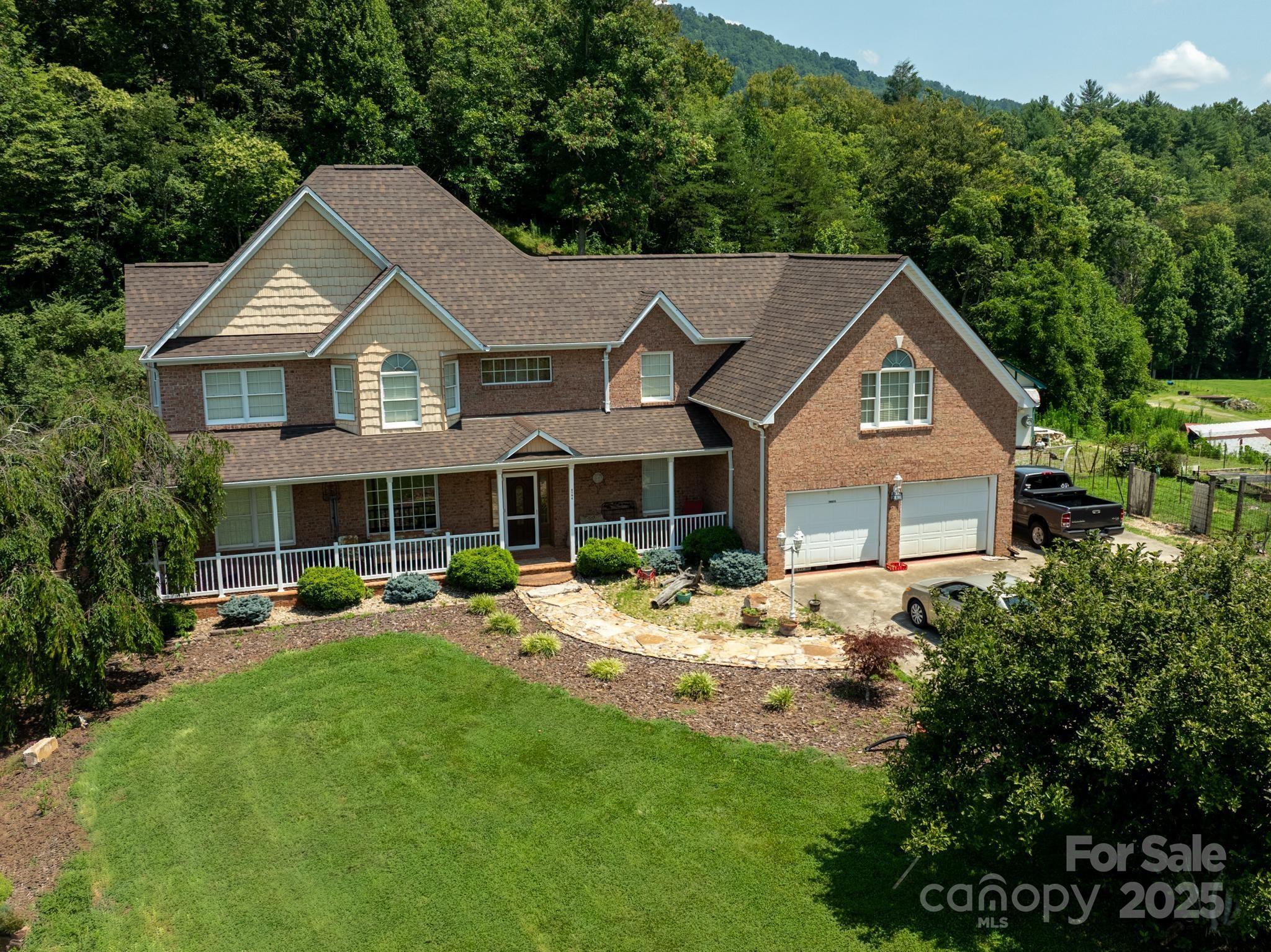 4594 Grandin Road Lenoir, NC 28645 - Photo 41 of 44 a front view of a house with a yard table and chairs