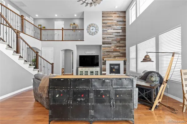 a living room with furniture a flat screen tv and a fireplace