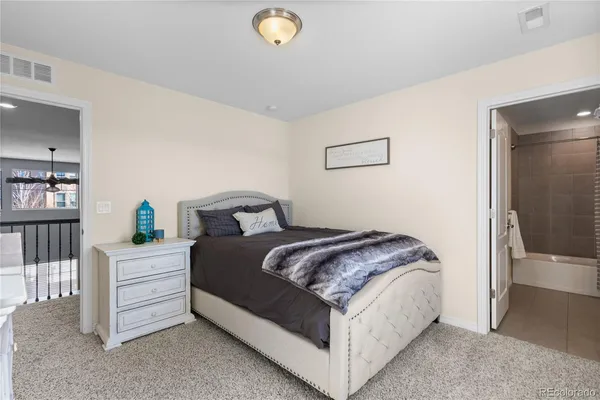 a bedroom with a bed and a book shelf