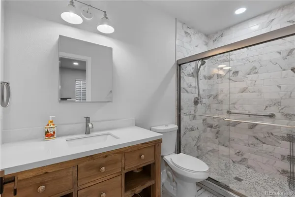 a bathroom with a sink mirror and vanity
