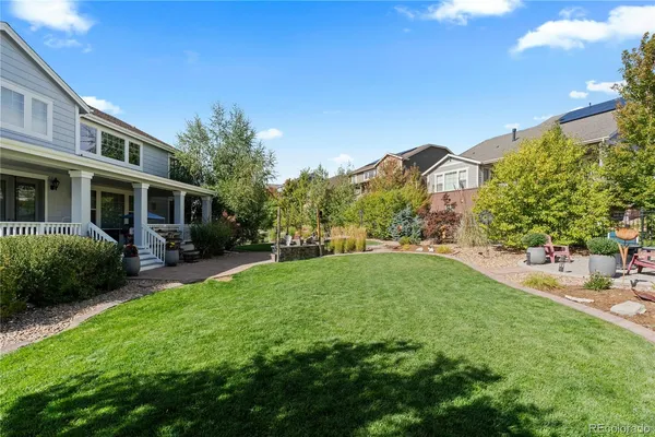 an aerial view of a house with a garden and lake view
