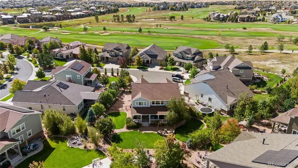 an aerial view of a house with a garden and swimming pool