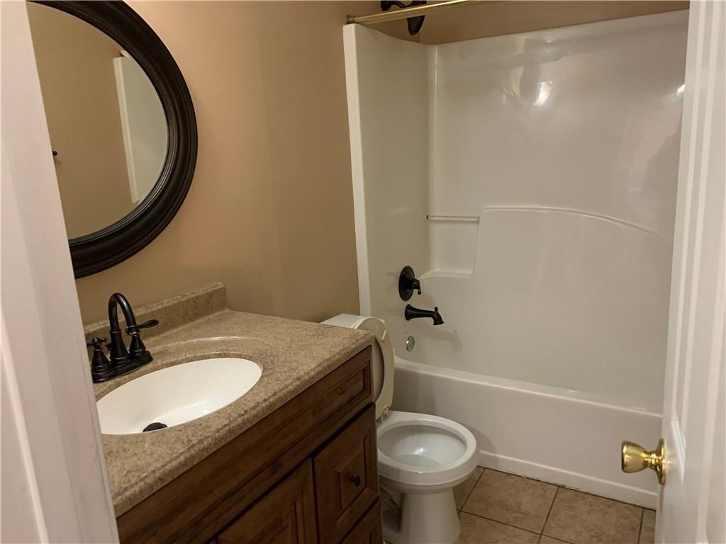 2195 Clayton Ridge Lithonia, GA 30058 - Photo 11 of 23 a bathroom with a granite countertop sink toilet and a mirror