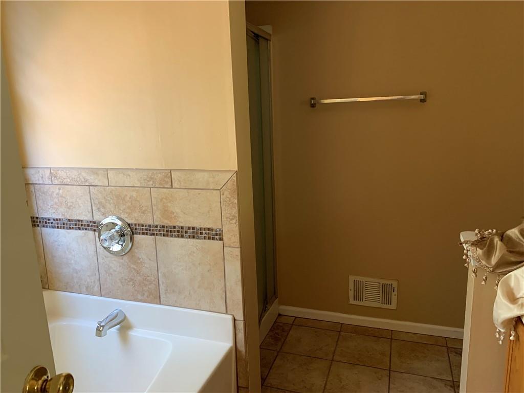 2195 Clayton Ridge Lithonia, GA 30058 - Photo 14 of 23 a bathroom with a sink and shower