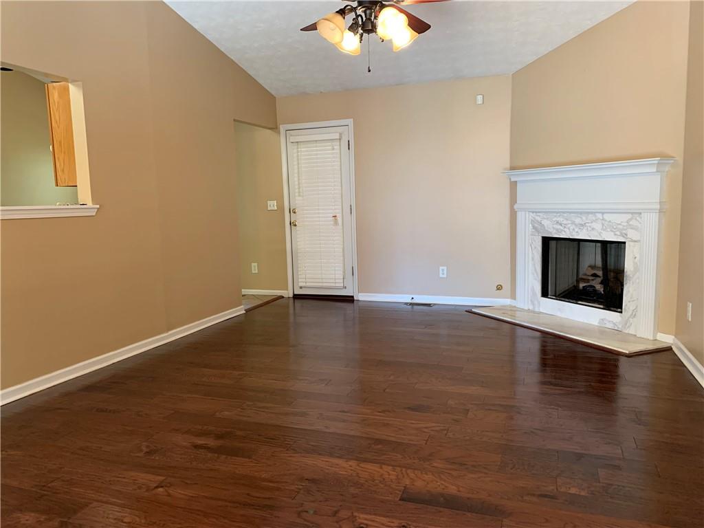2195 Clayton Ridge Lithonia, GA 30058 - Photo 4 of 23 a view of an empty room with wooden floor and a fireplace