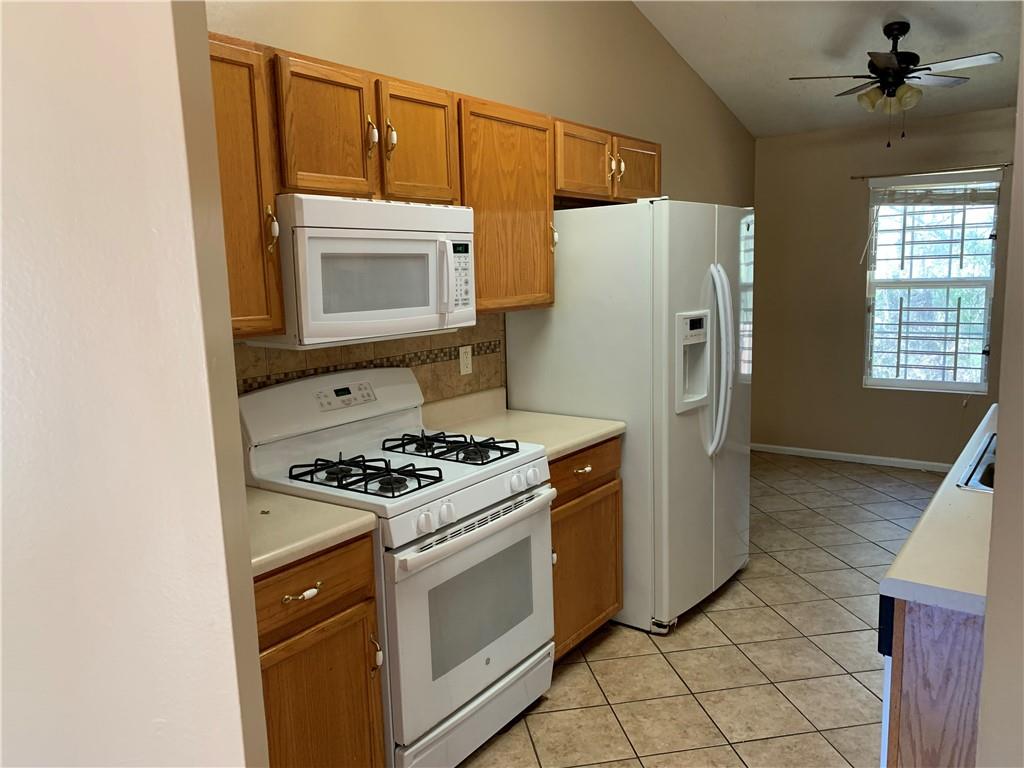 2195 Clayton Ridge Lithonia, GA 30058 - Photo 6 of 23 a kitchen with a stove top oven and refrigerator