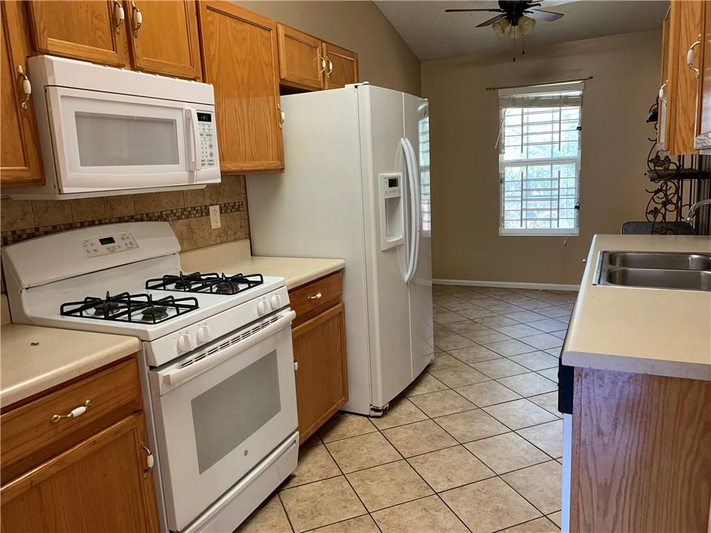 2195 Clayton Ridge Lithonia, GA 30058 - Photo 7 of 23 a kitchen with a stove a refrigerator and a sink