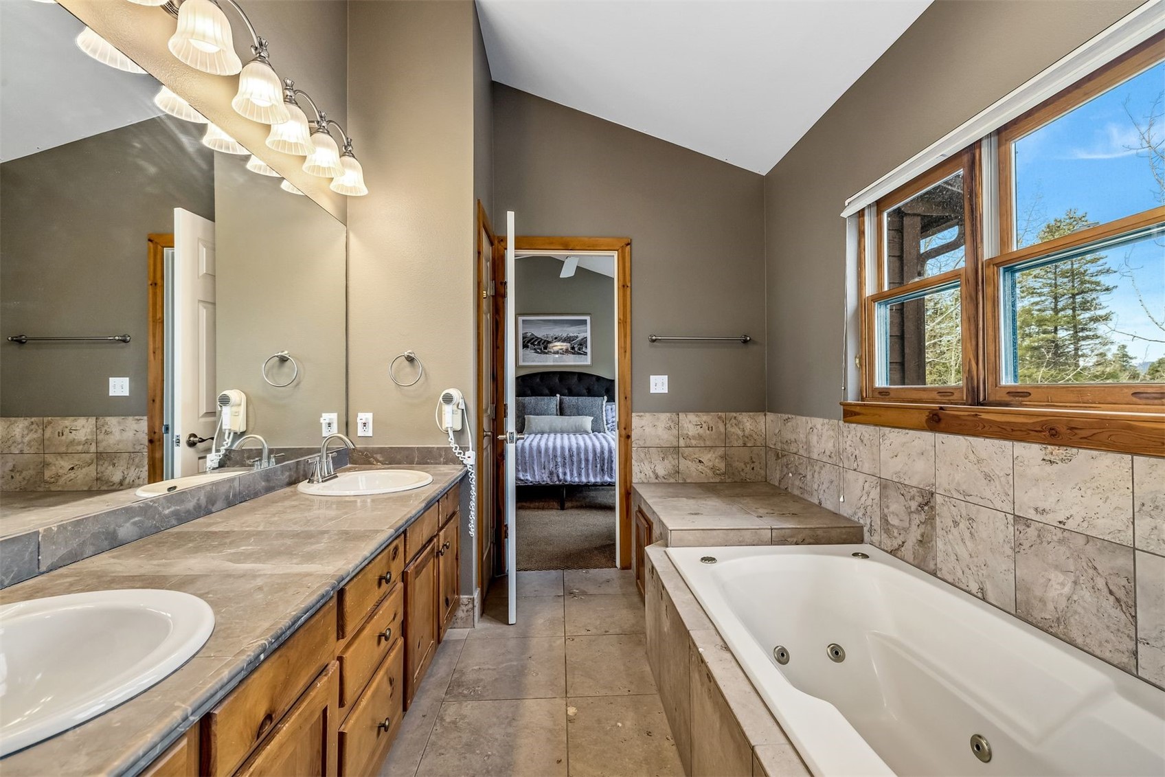 71 Starfire Lane, Unit 1978 Keystone, CO 80435 - Photo 18 of 40 a bathroom with a granite countertop tub a sink and a large mirror