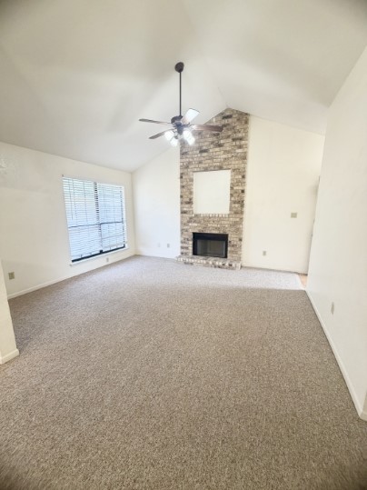 an empty room with fireplace and windows