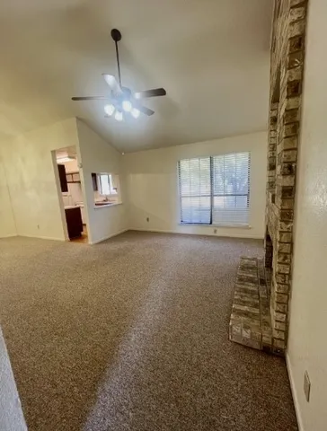 en empty room with windows and ceiling fan