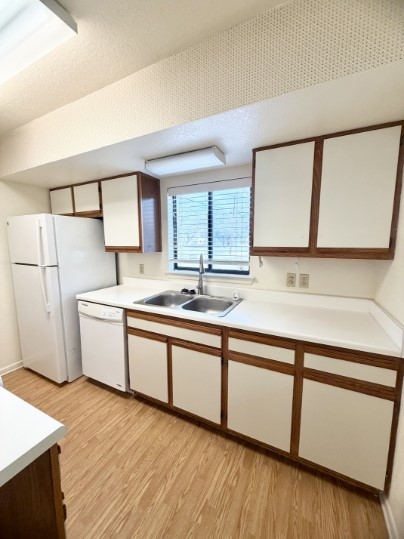 728 West San Antonio Street, Unit 728A Lockhart, TX 78644 - Photo 4 of 12 a kitchen with a sink a refrigerator and a stove top oven
