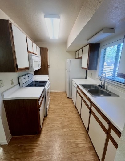 728 West San Antonio Street, Unit 728A Lockhart, TX 78644 - Photo 5 of 11 a kitchen with stainless steel appliances a sink stove and cabinets