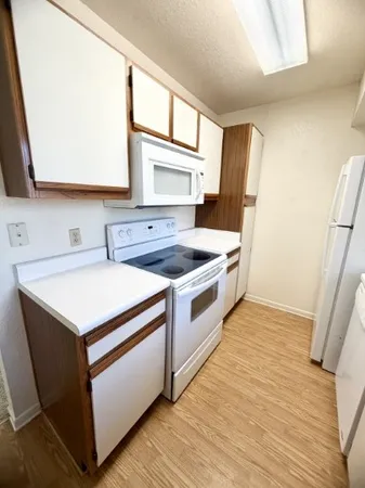 a kitchen with a stove sink and a mirror