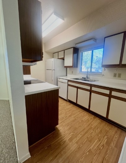 728 West San Antonio Street, Unit 728A Lockhart, TX 78644 - Photo 6 of 11 a kitchen with stainless steel appliances granite countertop a sink stove and wooden floor