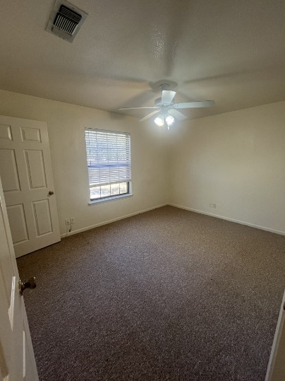 728 West San Antonio Street, Unit 728A Lockhart, TX 78644 - Photo 7 of 11 an empty room with a ceiling fan and a window