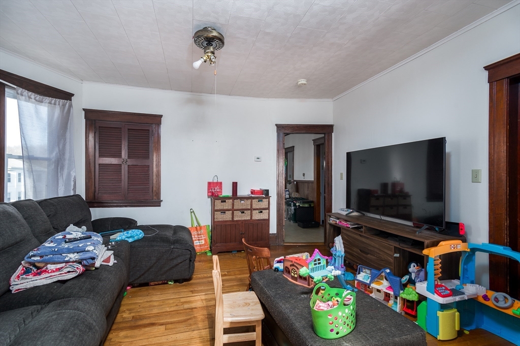 63 Pilgrim Avenue Worcester, MA 01604 - Photo 11 of 23 a living room with furniture and a flat screen tv