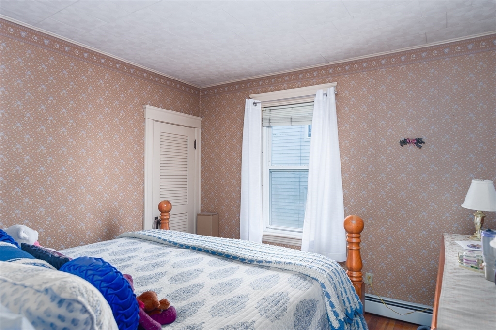 63 Pilgrim Avenue Worcester, MA 01604 - Photo 21 of 23 a bedroom with a bed and a window