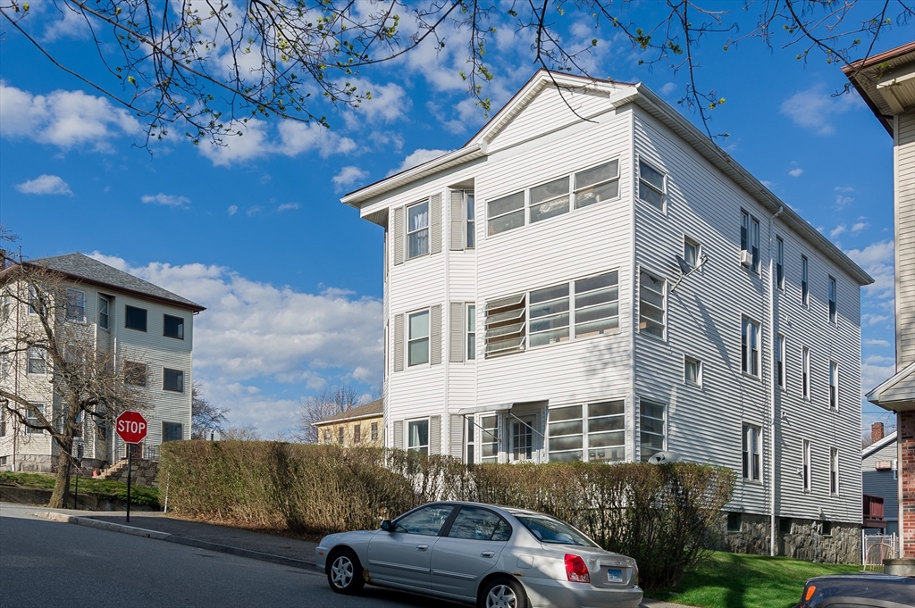 63 Pilgrim Avenue Worcester, MA 01604 - Photo 3 of 23 a view of a cars park in front of a building
