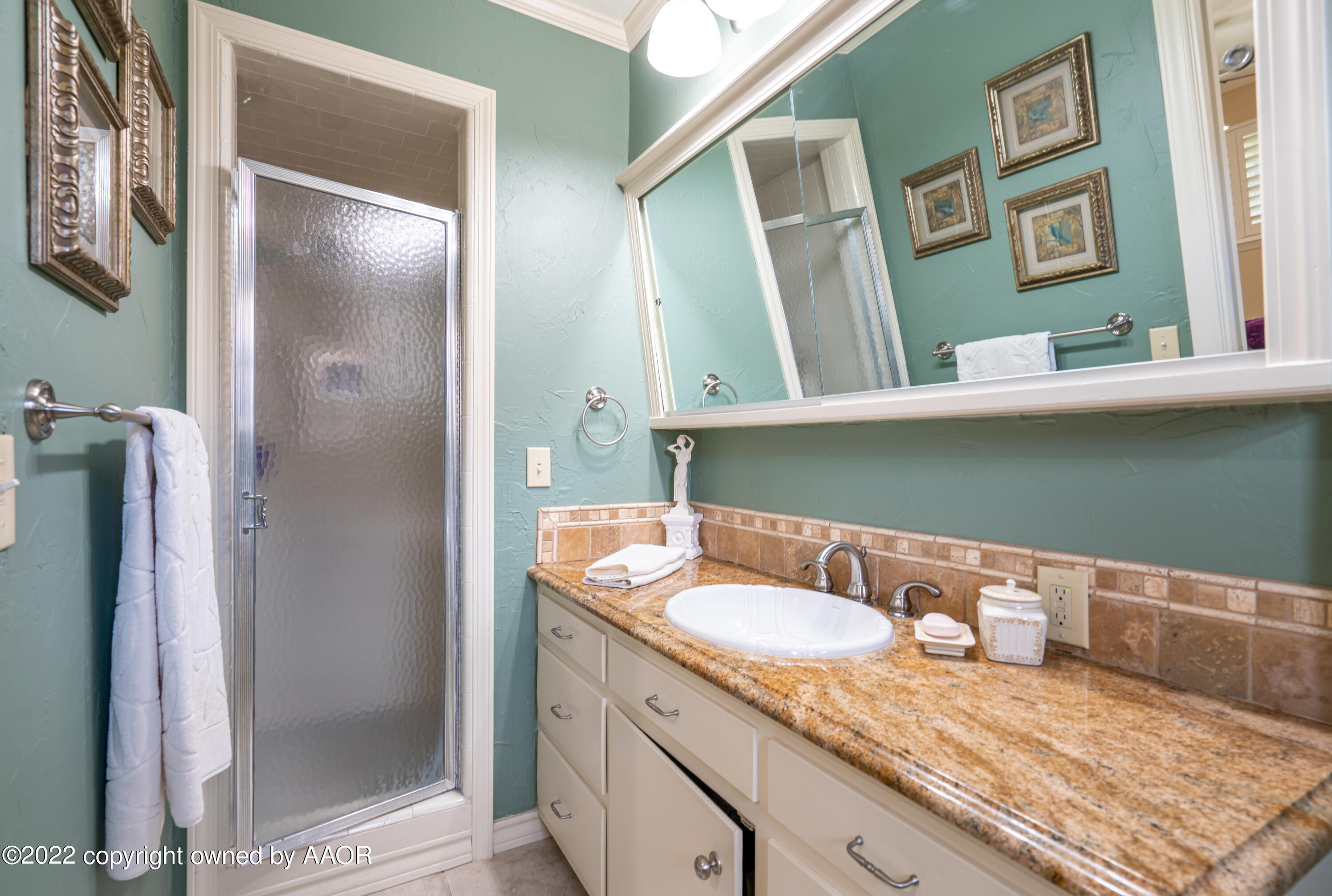 6209 Dreyfuss Road Amarillo, TX 79106 - Photo 17 of 28 a bathroom with a granite countertop sink and a mirror