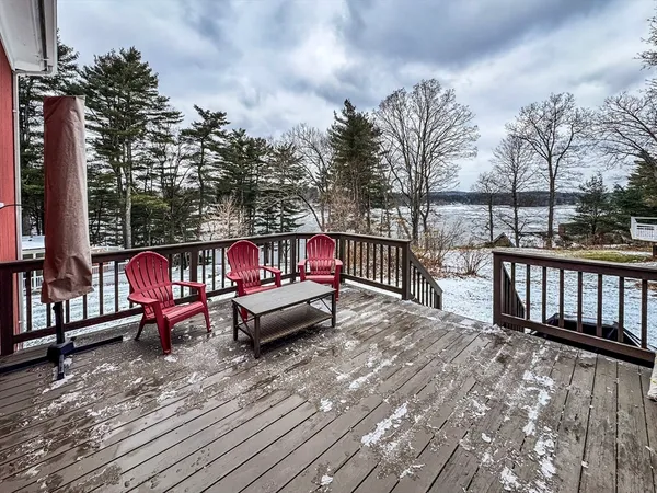 a view of a roof deck with wooden fence and sitting area