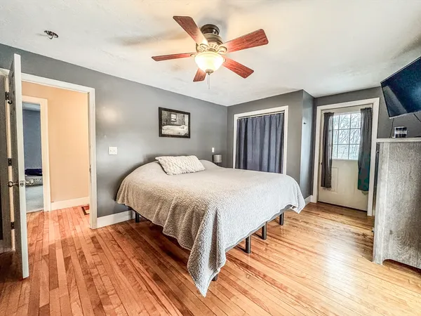 a spacious bedroom with a bed and a ceiling fan