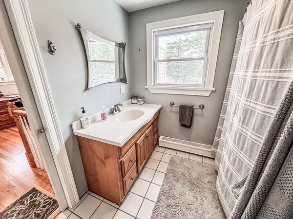 a bathroom with sink a mirror a vanity and a window