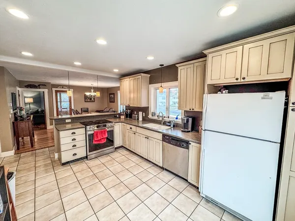a kitchen with stainless steel appliances granite countertop a refrigerator sink and cabinets