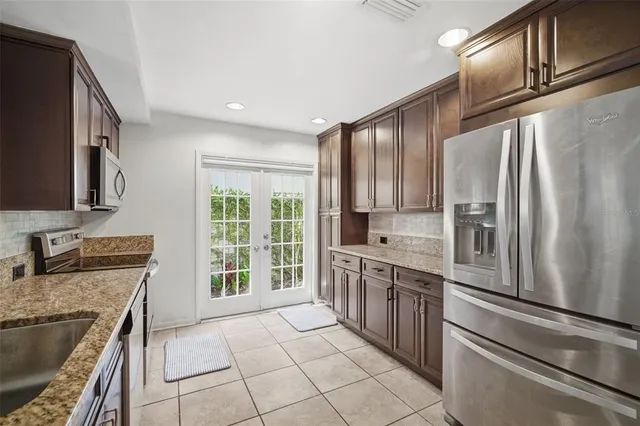 a kitchen with granite countertop a stove and a microwave