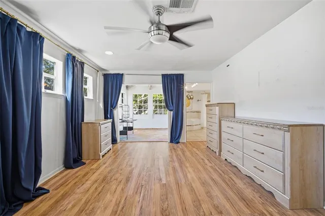 a bathroom with a tub sink mirror and shower